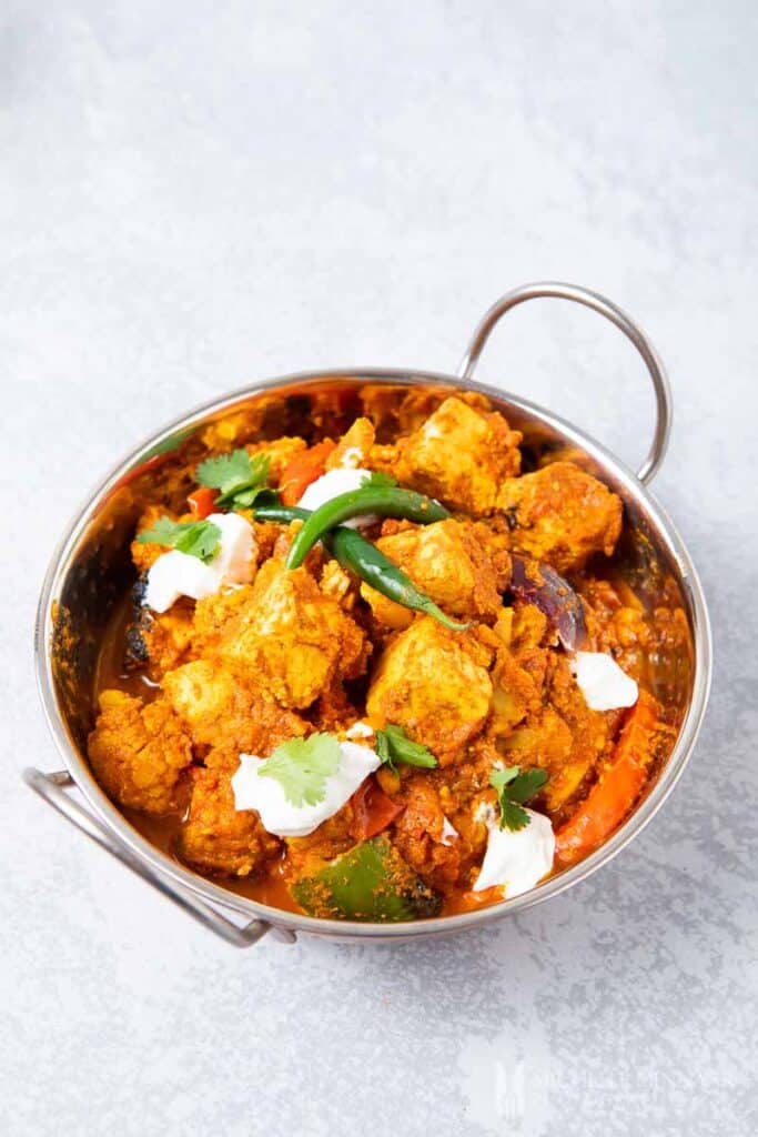 A bowl of orange tawa paneer tikka