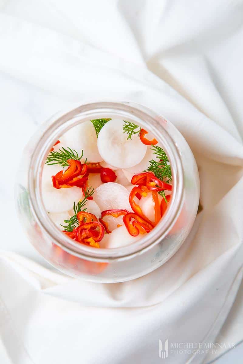 Clear jar of pickled daikon