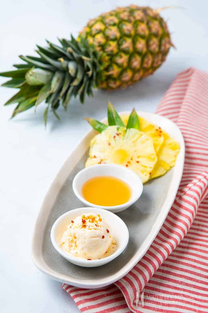 Scoop of pineapple ice cream and a whole pineapple