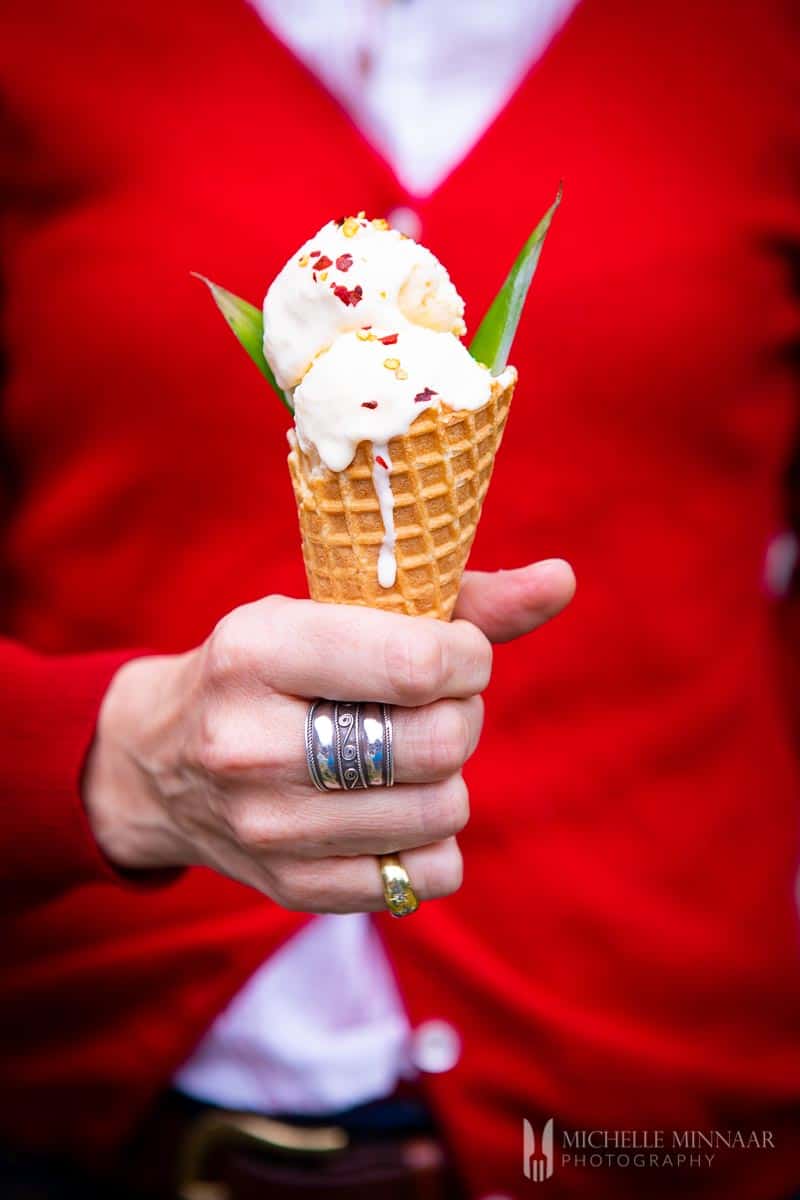 Two scoops of pineapple ice cream on a sugar cone 