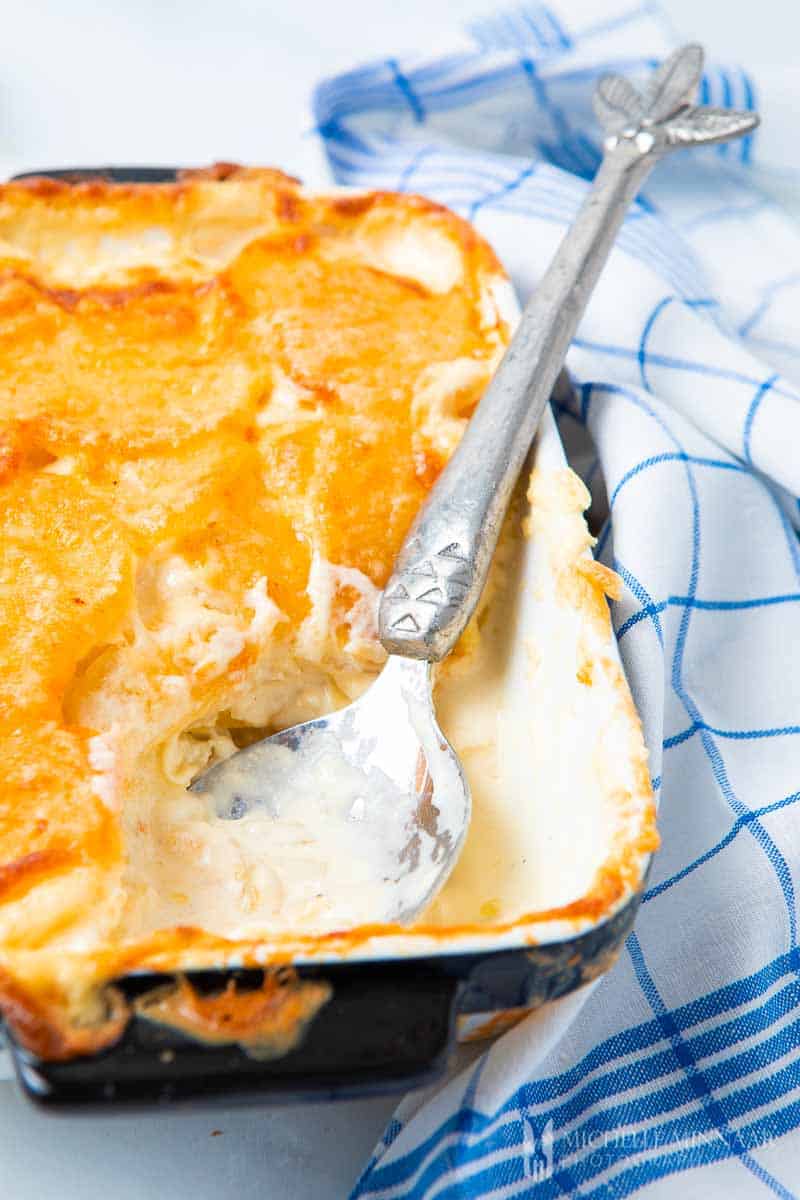 Close up of a spoonful of cheesy gratin dauphinois