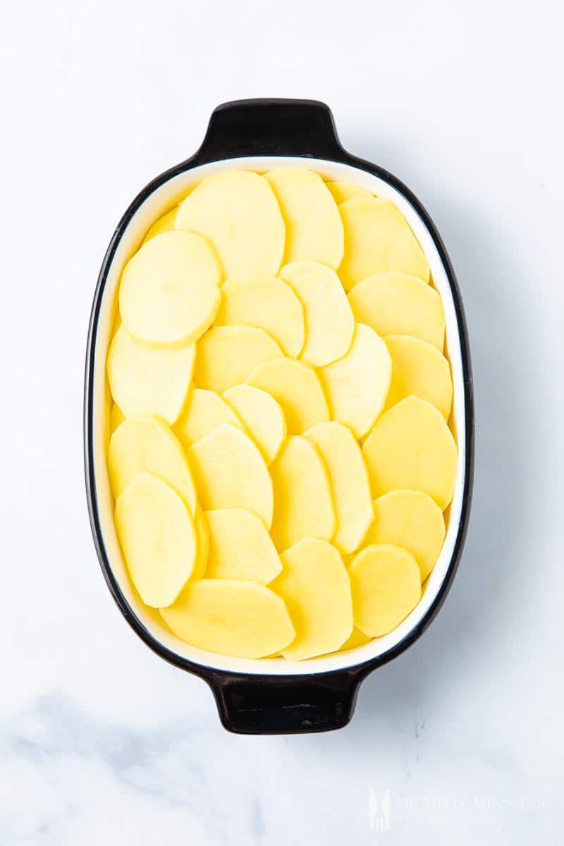 A casserole dish of sliced potatoes