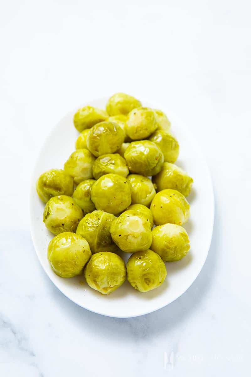 A large plate of green sous vide brussels sprouts