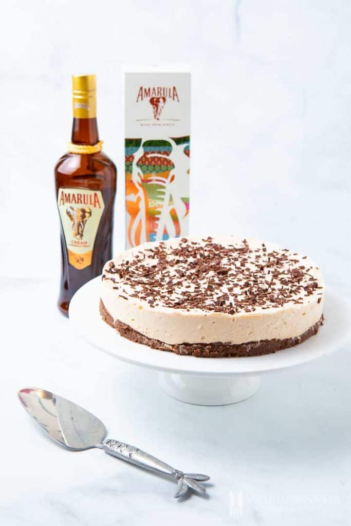 A cheesecake and a bottle of liquor