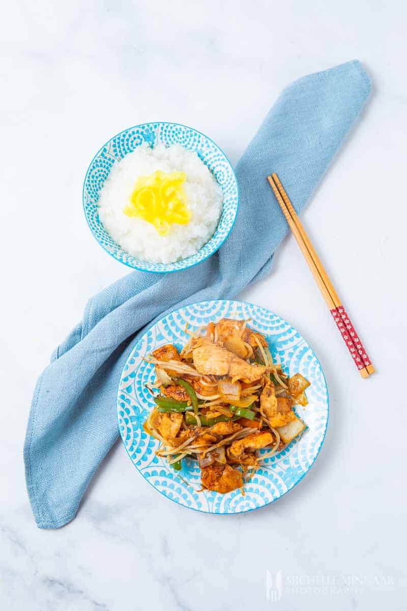 A plate of yasai itame and a bowl of white rice