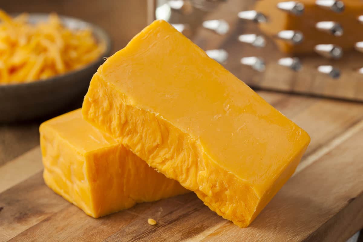 cheese brick in front of a grater