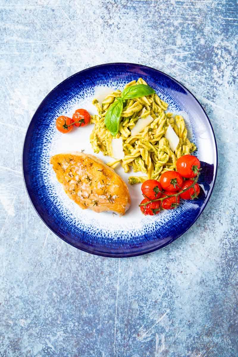 A plate of chicken pesto pasta