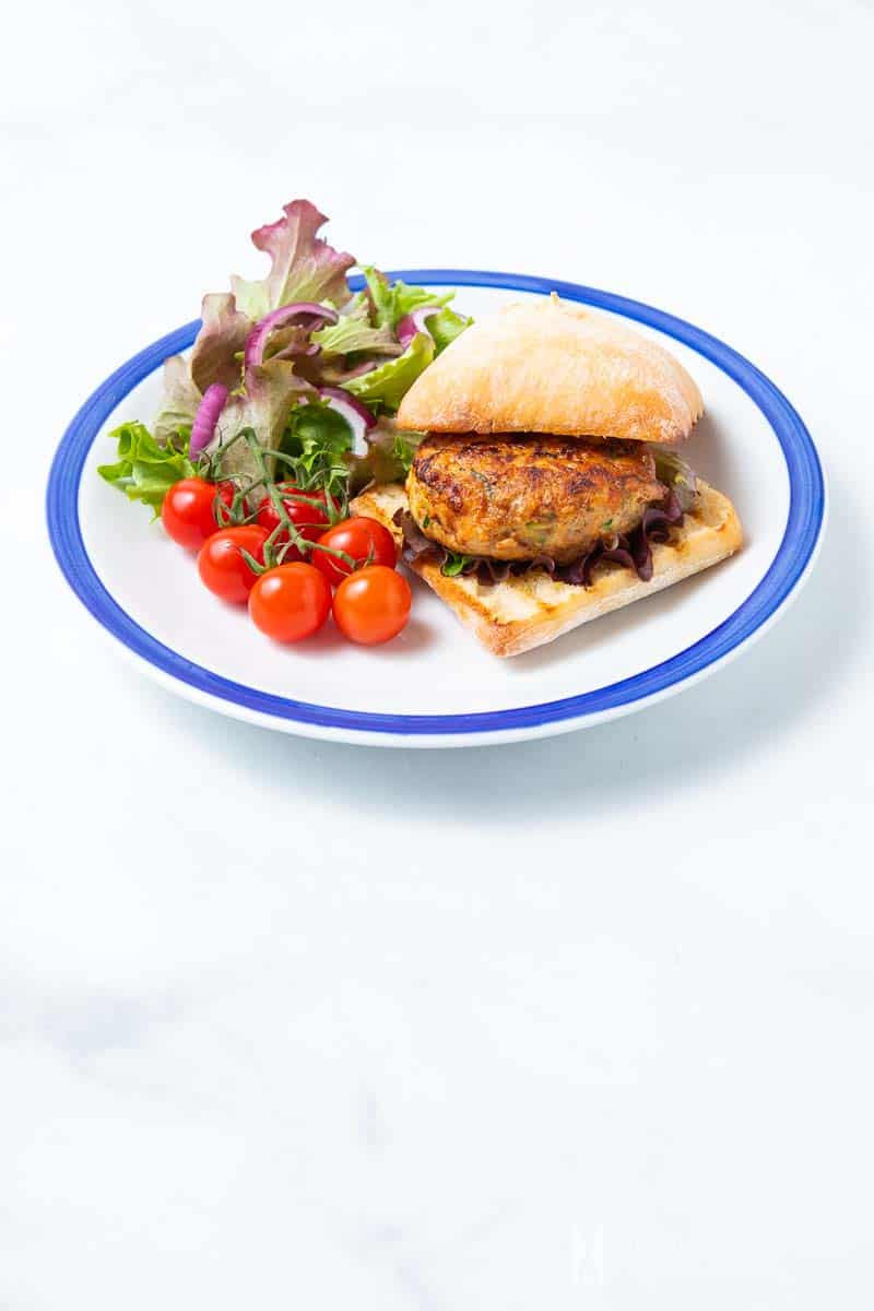 A plate of Chicken Rissoles with tomatoes and salad