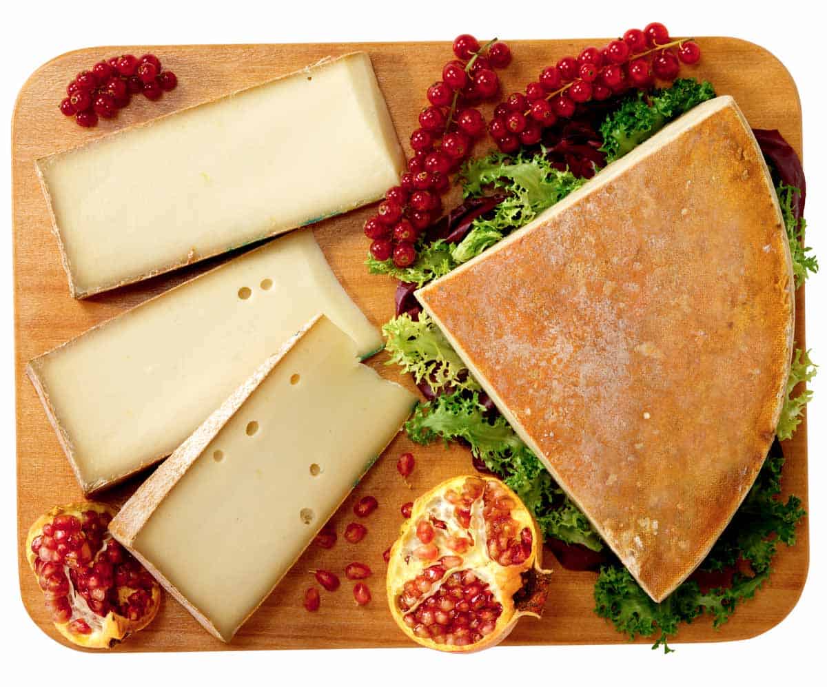 A block of white fontina cheese and fruit