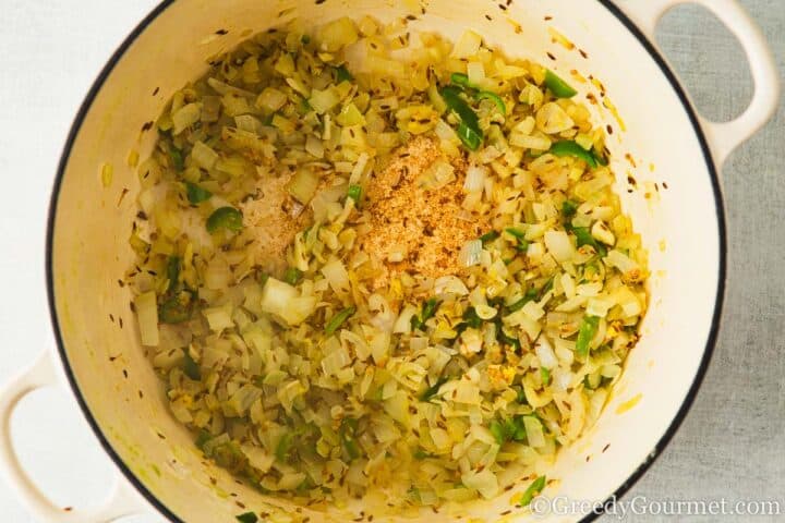 Frying onion and chili in a pan.