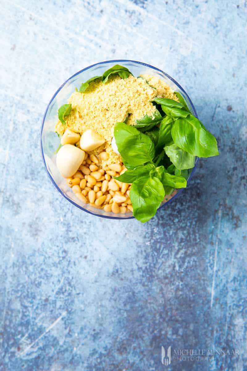 Ingredients to make dairy free pesto in a food processor 