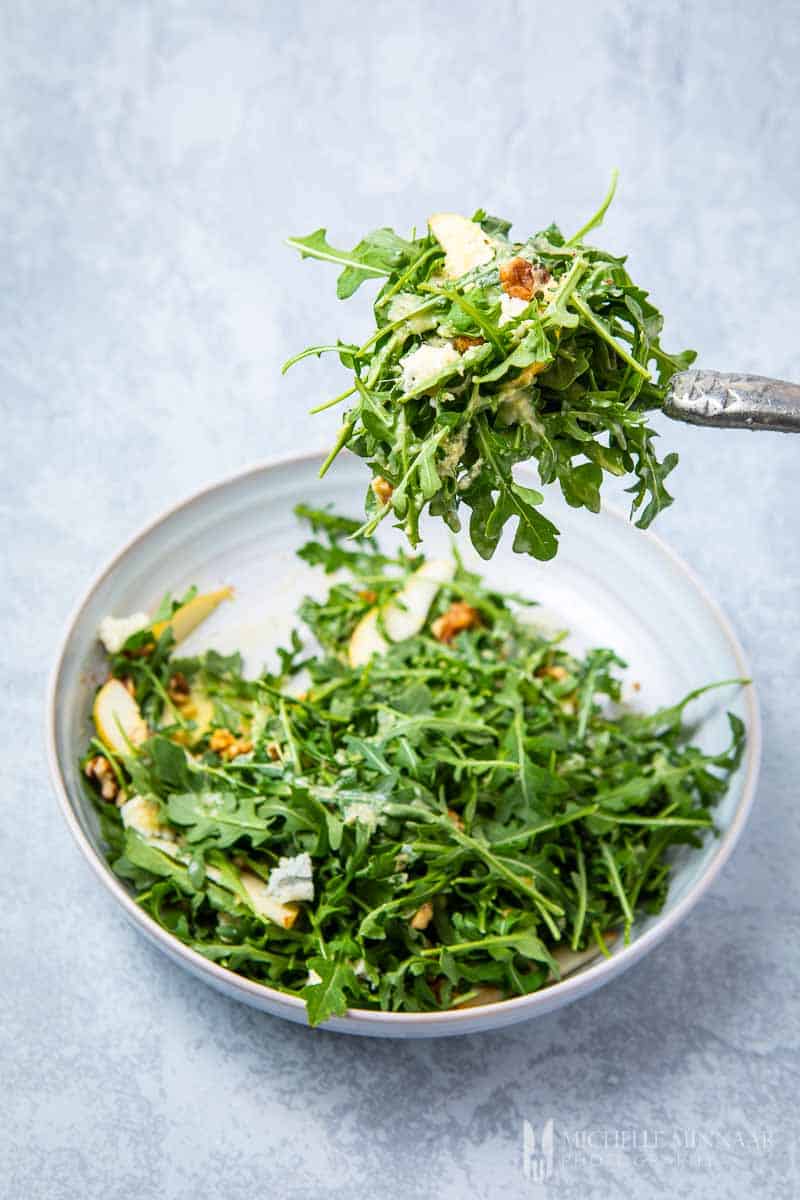 A salad with ginger dressing on a fork