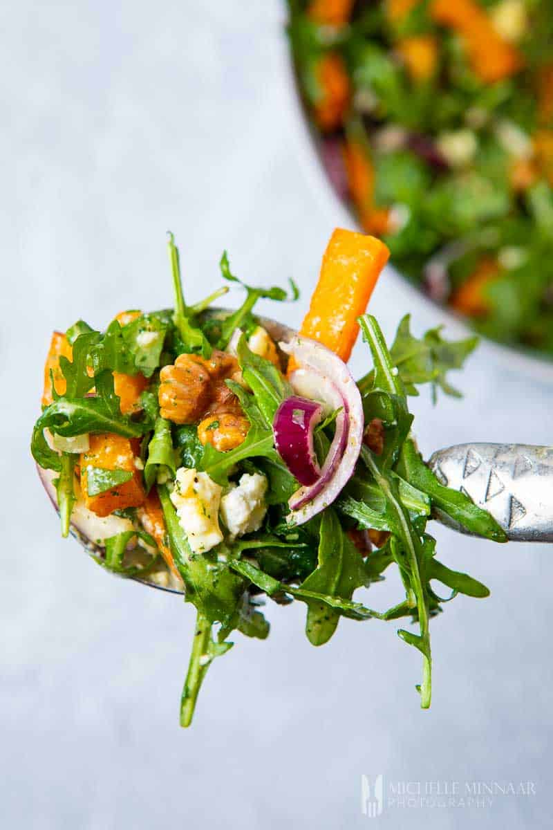 A forkful of pumpkin and feta salad