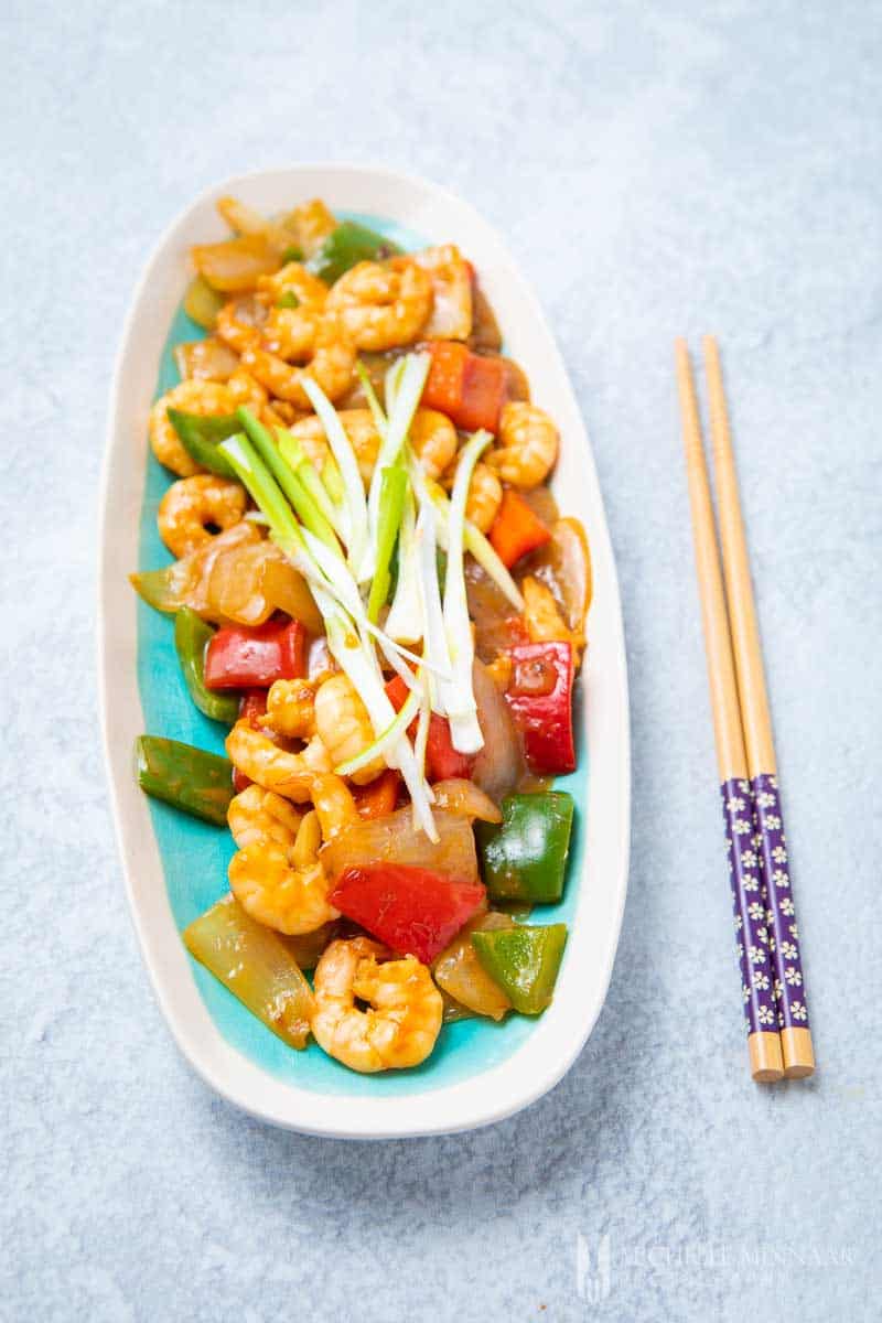 A long plate of shrimp in oyster sauce