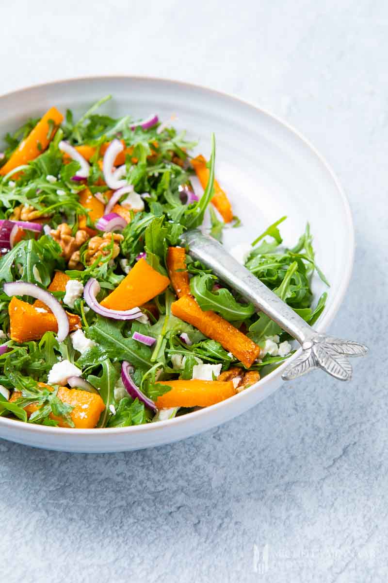 A large bowl of pumpkin and feta salad