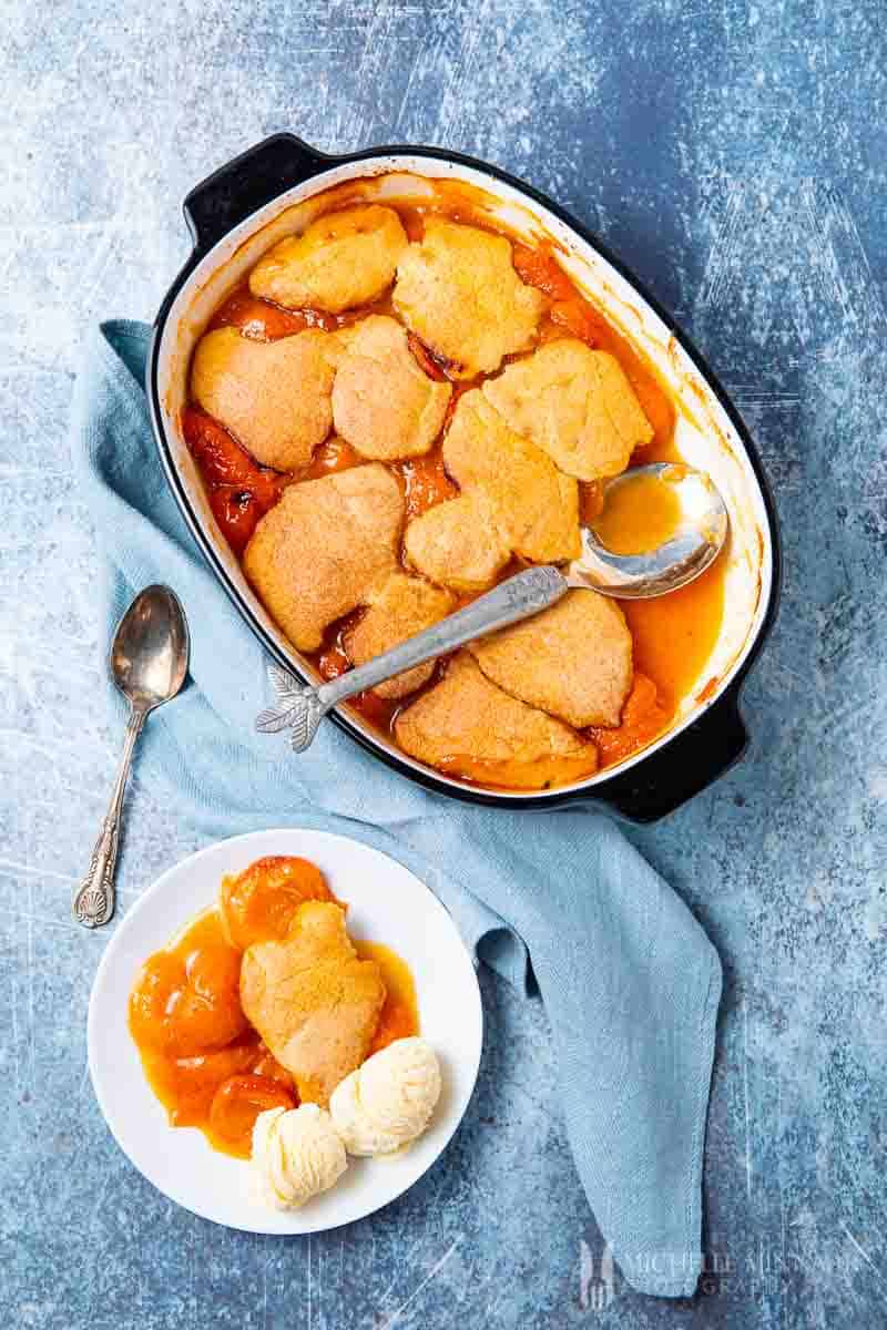 A complete apricot cobbler with a side dish 