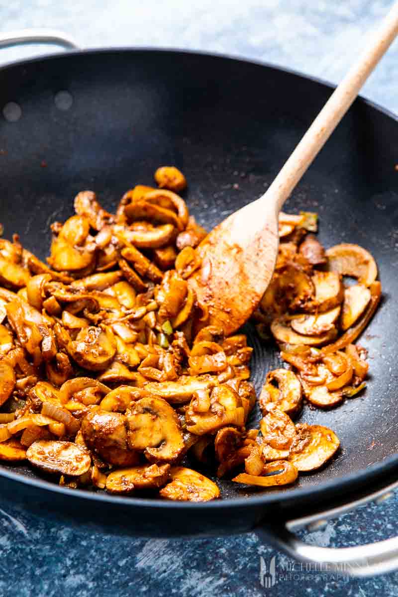 Mushrooms being sauteed in pan 