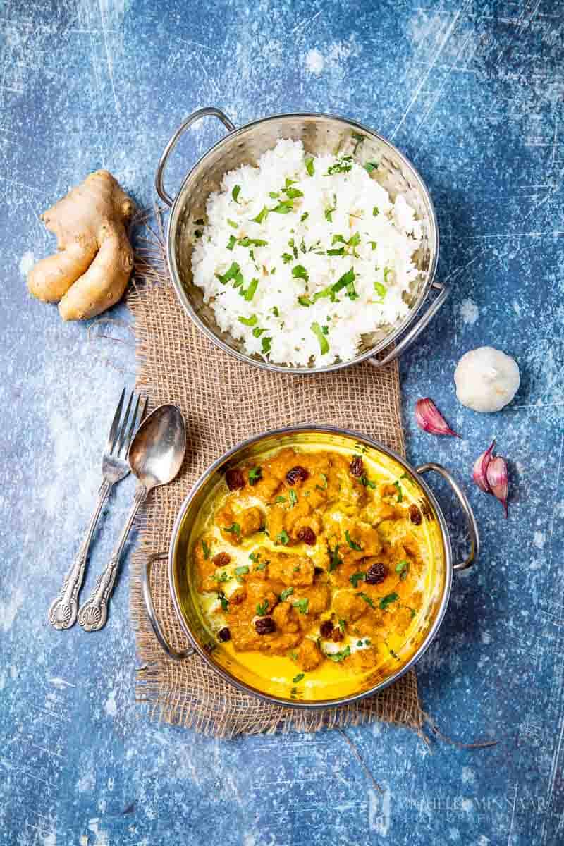 A bowl of lamb pasanda and white rice 