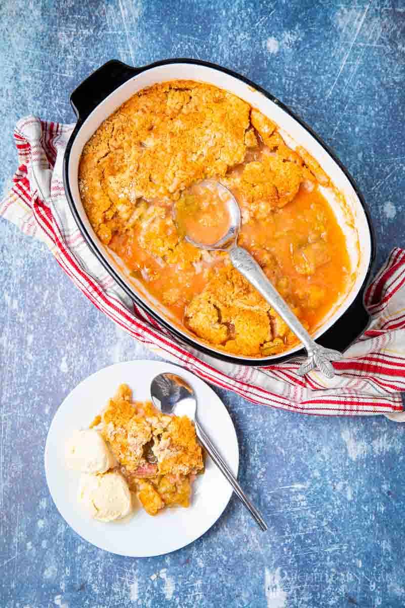 A rhubarb dump cake in a white casserole dish