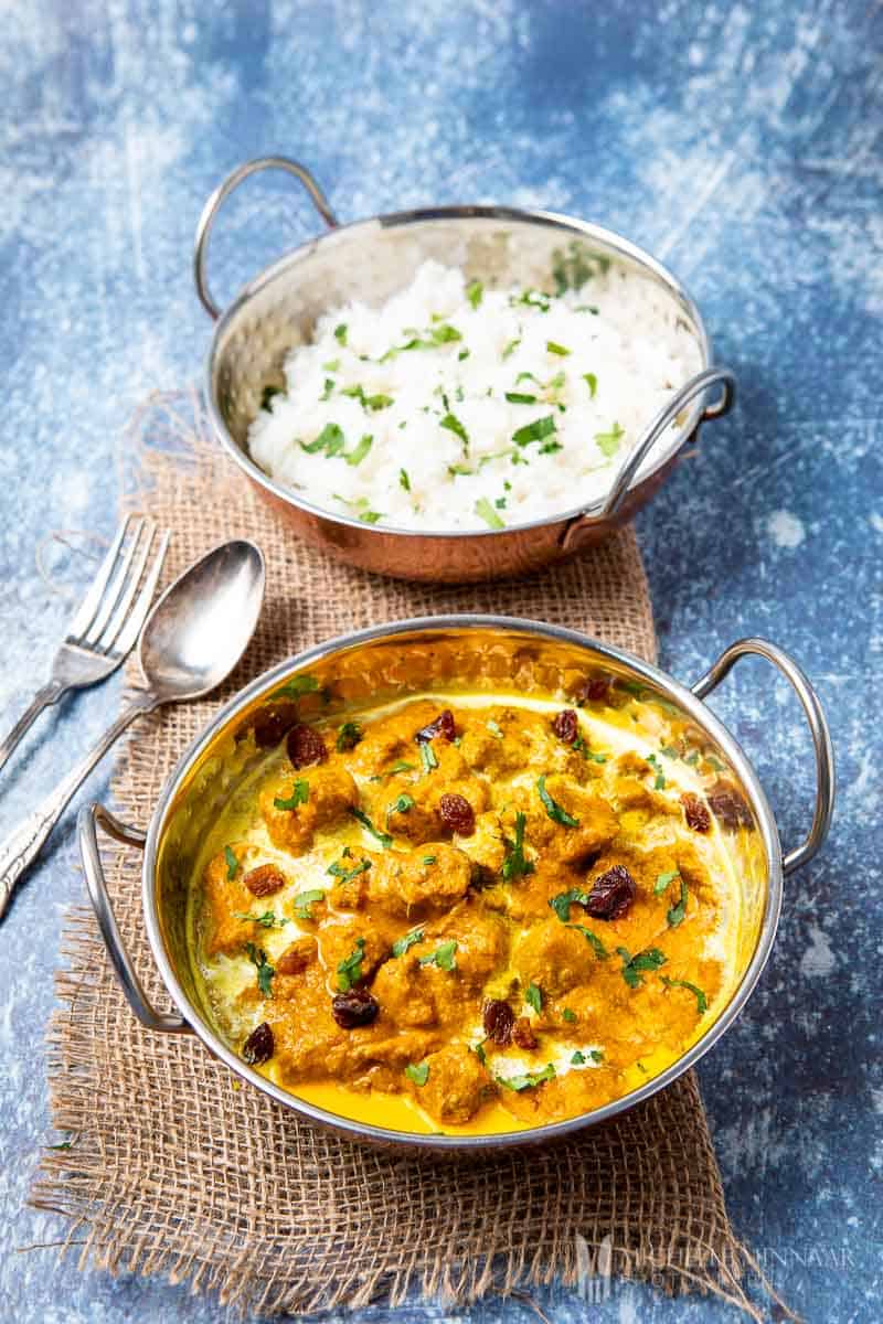 Orange Lamb stew in a bowl and white rice 