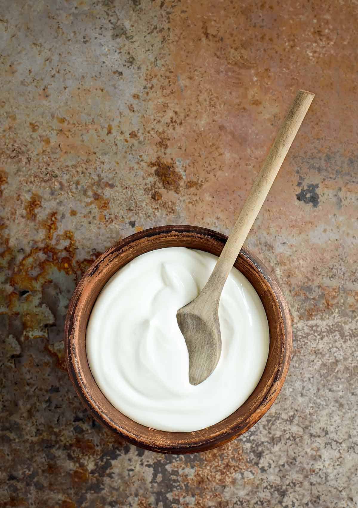 A wooden bowl of white cream