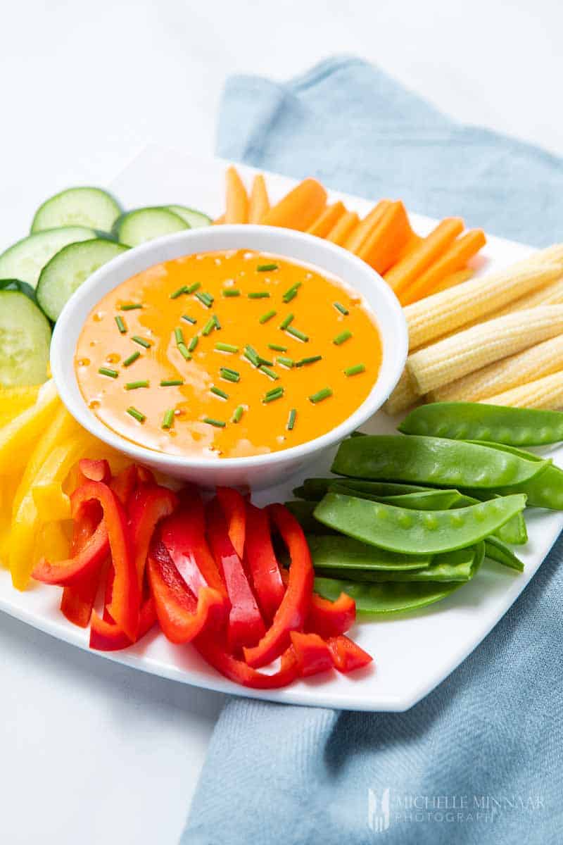 Orange harissa aioli with chives and vegetables 