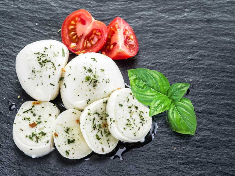 Slices of seasoned mozzarella cheese