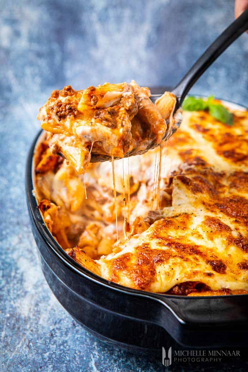 Slice of bolognese pasta bake on a spoon 