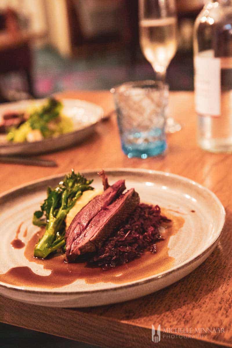 The duck and asparagus on a plate 
