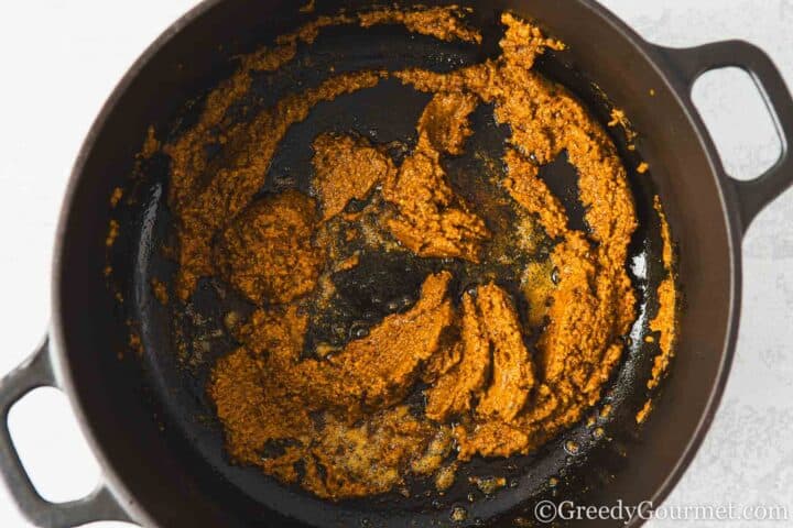 frying korma paste.