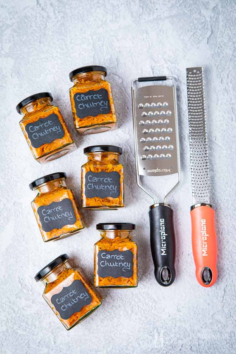 Jars of carrot chutney and a grater and zester