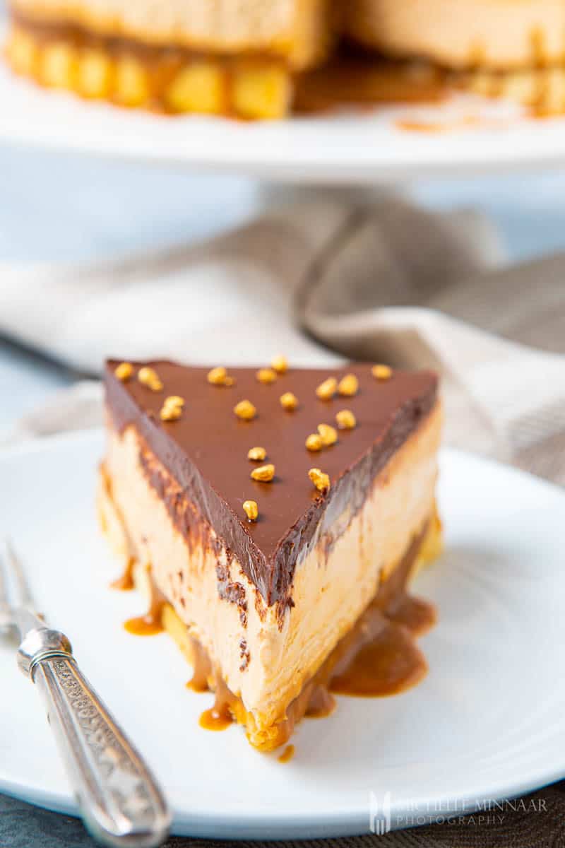 Slice of layered Millionaire's cheesecake