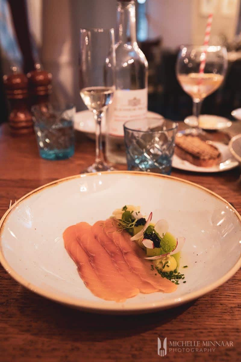 Raw seafood on a plate as sashimi 