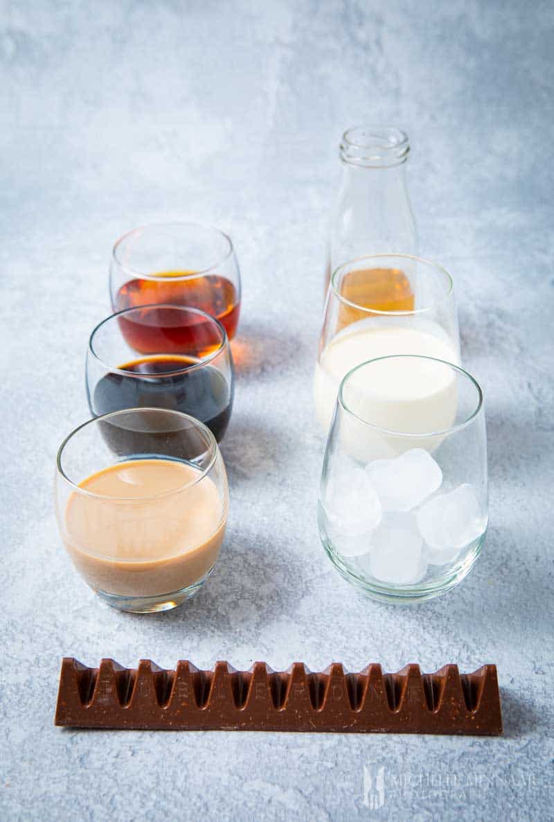 Glasses of liquid ingredients to make a Toblerone cocktail