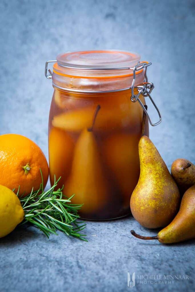 Jar of brown brandied pears and whole pears