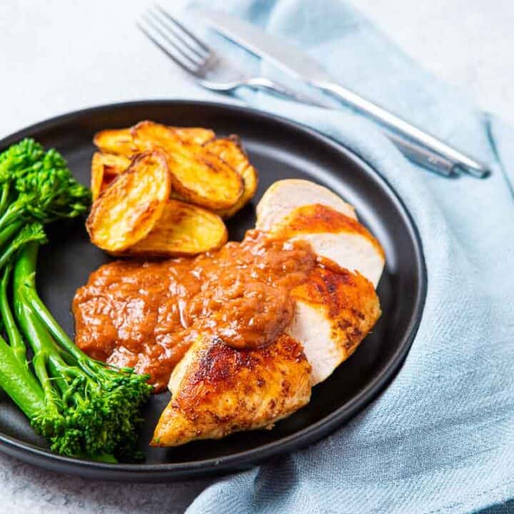 Plate of Chicken with Rhubarb Sauce and a side of potatoes and broccolini