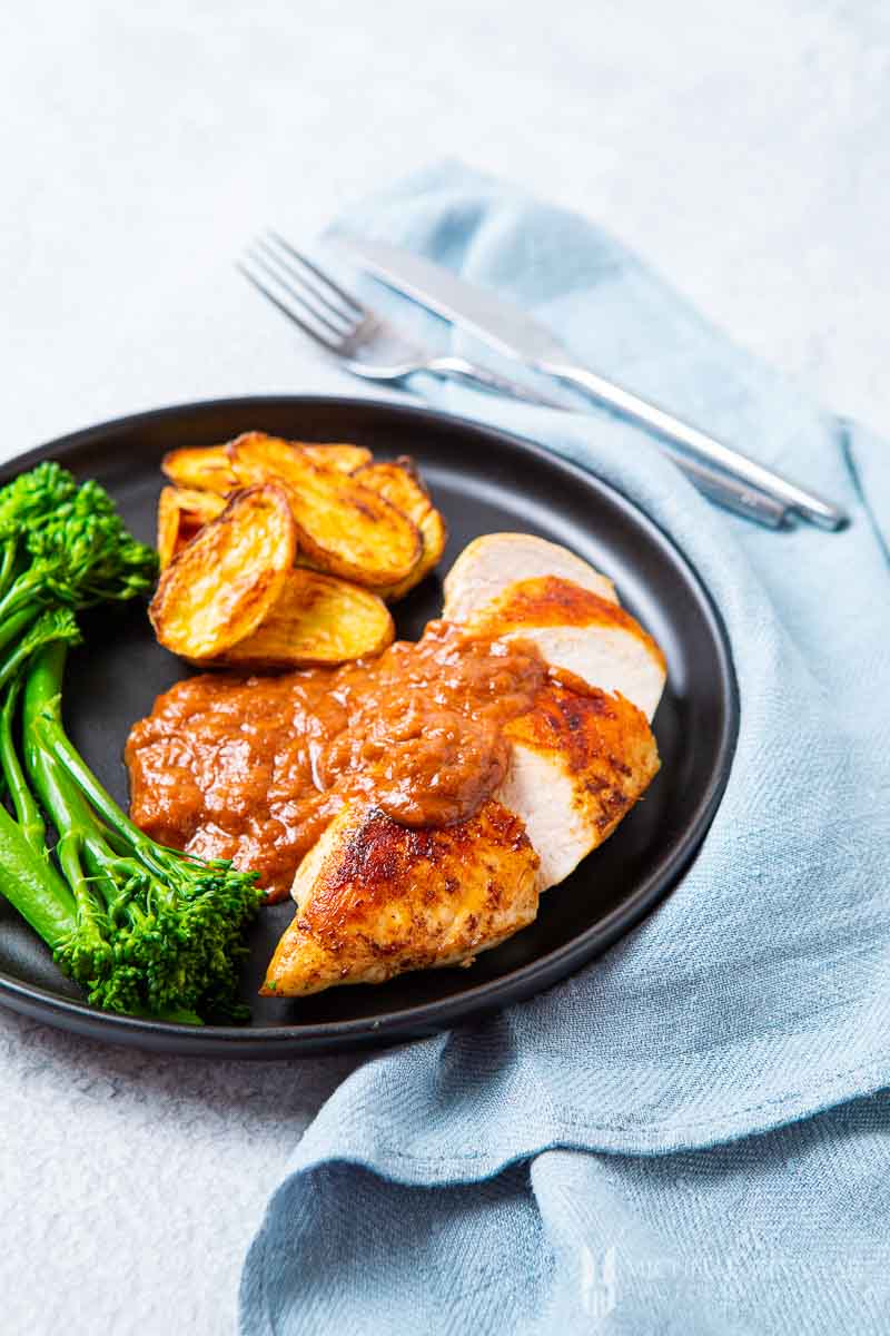 Plate of Chicken with Rhubarb Sauce and a side of potatoes and broccolini