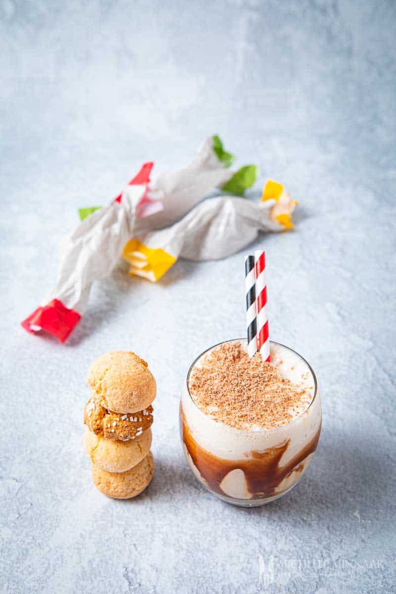 A glass of Toblerone cocktail with biscuits