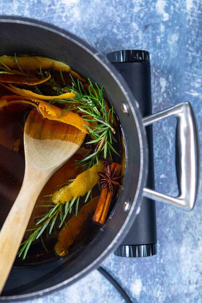 Sauce pan of liquid and rosemary 