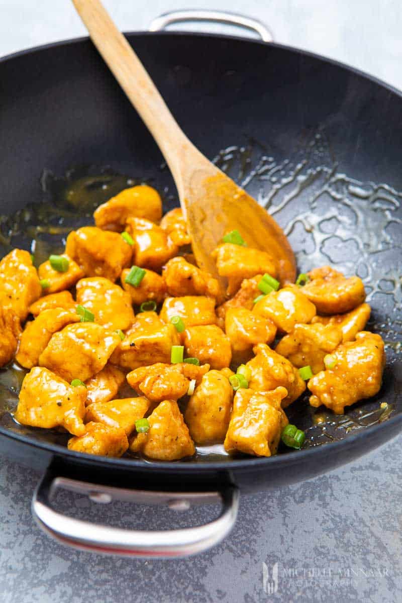 Close up of Orange peel chicken in a saute pan 