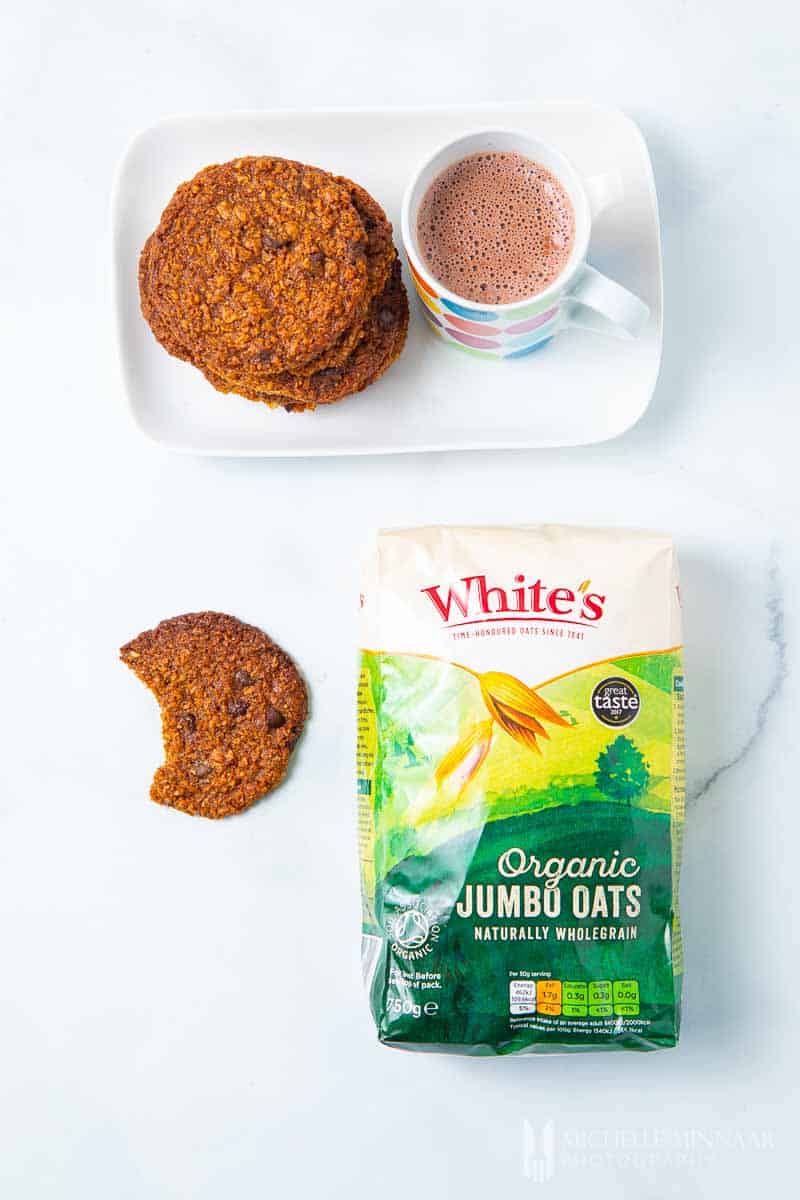 Plate of Vegan Oat Cookies and a bag of whites oats