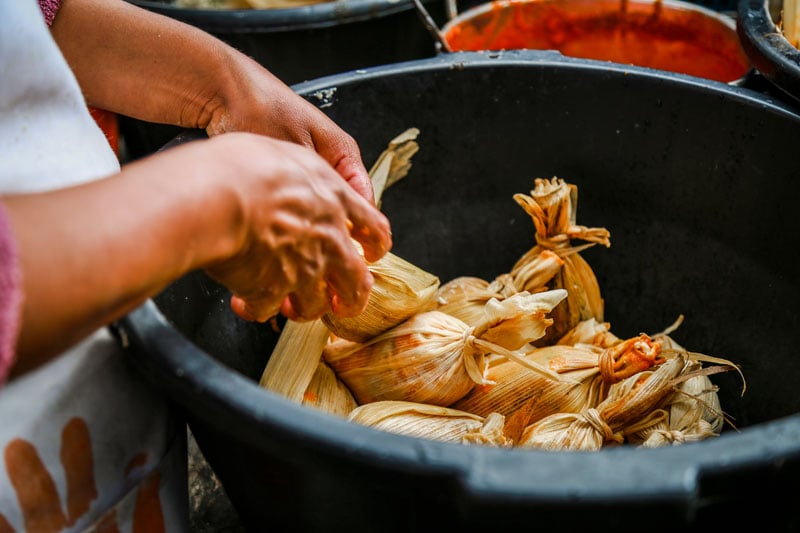 Tamales being made in banana leaves 