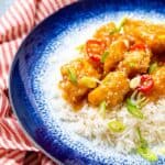 Plate of white rice topped with honey chicken chilli