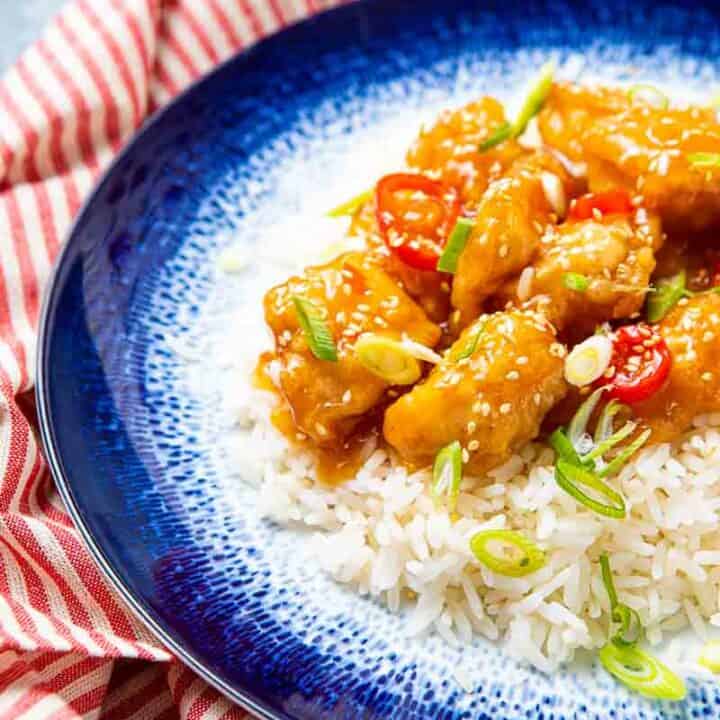 Plate of white rice topped with honey chicken chilli