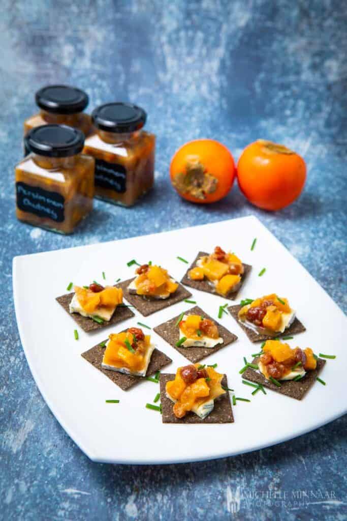 Tapas of persimmon chutney on crackers