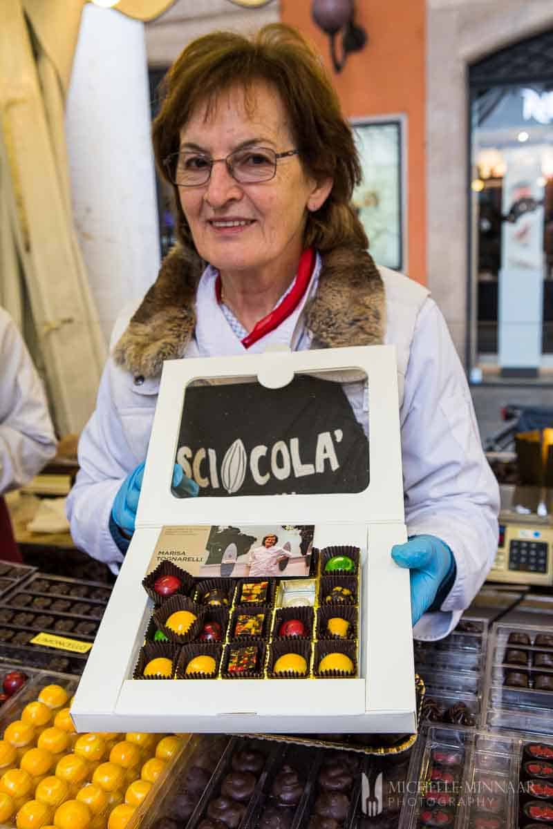 Lady holding box of chocolates at Sciocola chocolate event in Modena, Italy.