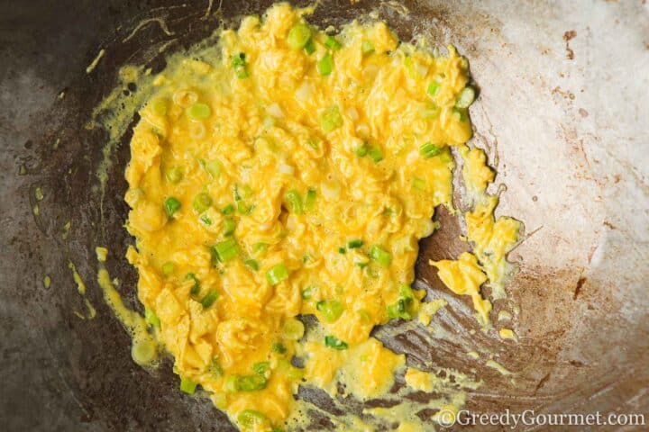 Frying egg and spring onion.