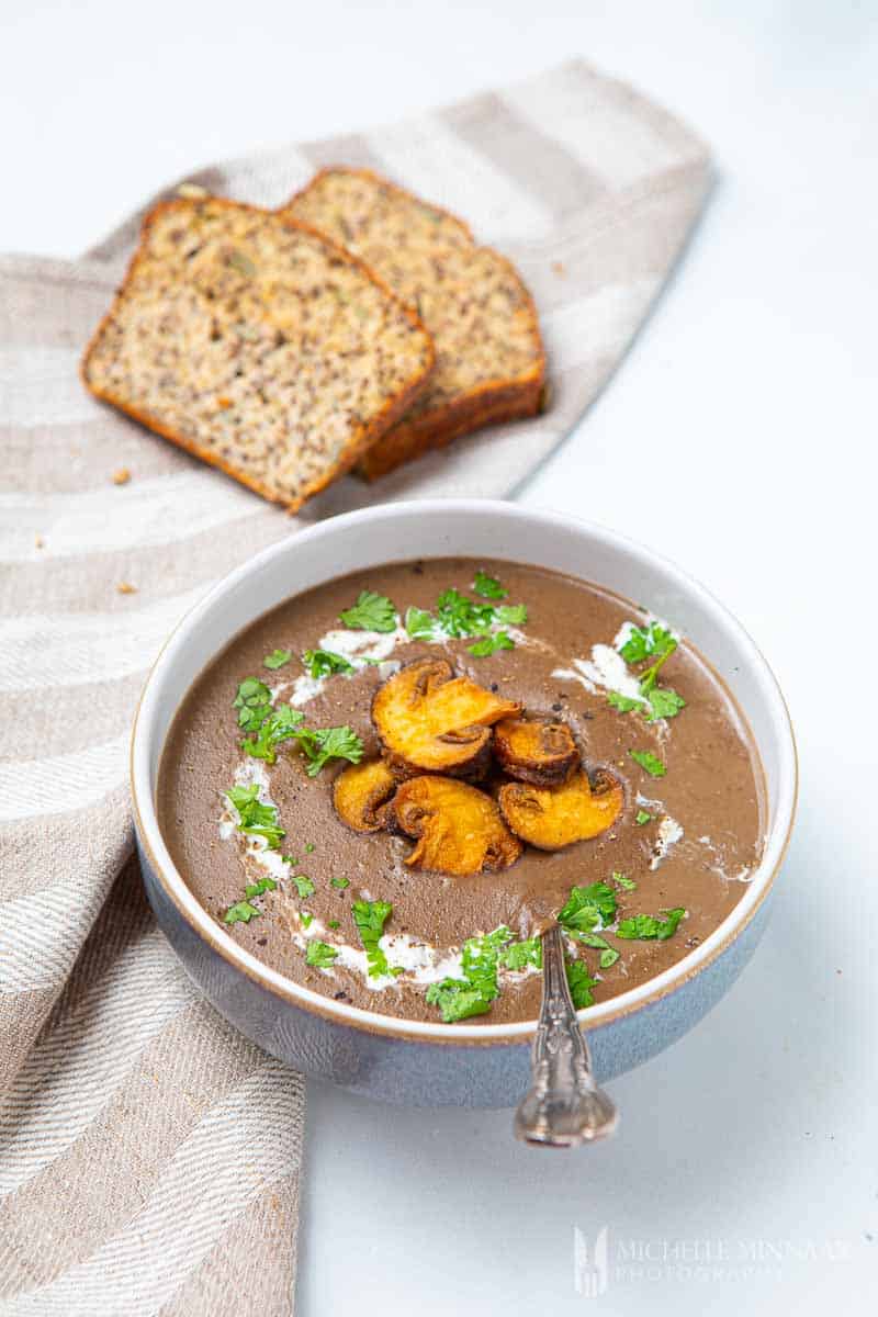 Bowl of soup maker mushroom soup and brown bread slices