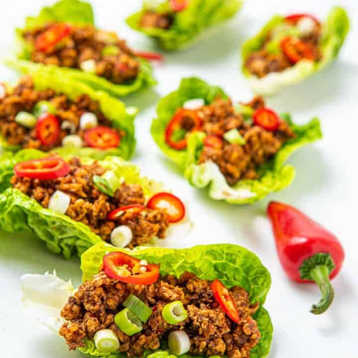 Close up of lettuce meat cups with red peppers as garnsih