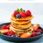 Stack of crempog (pancakes) with fresh fruit